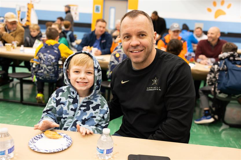 Trinity Elementary students eat donuts with dudes